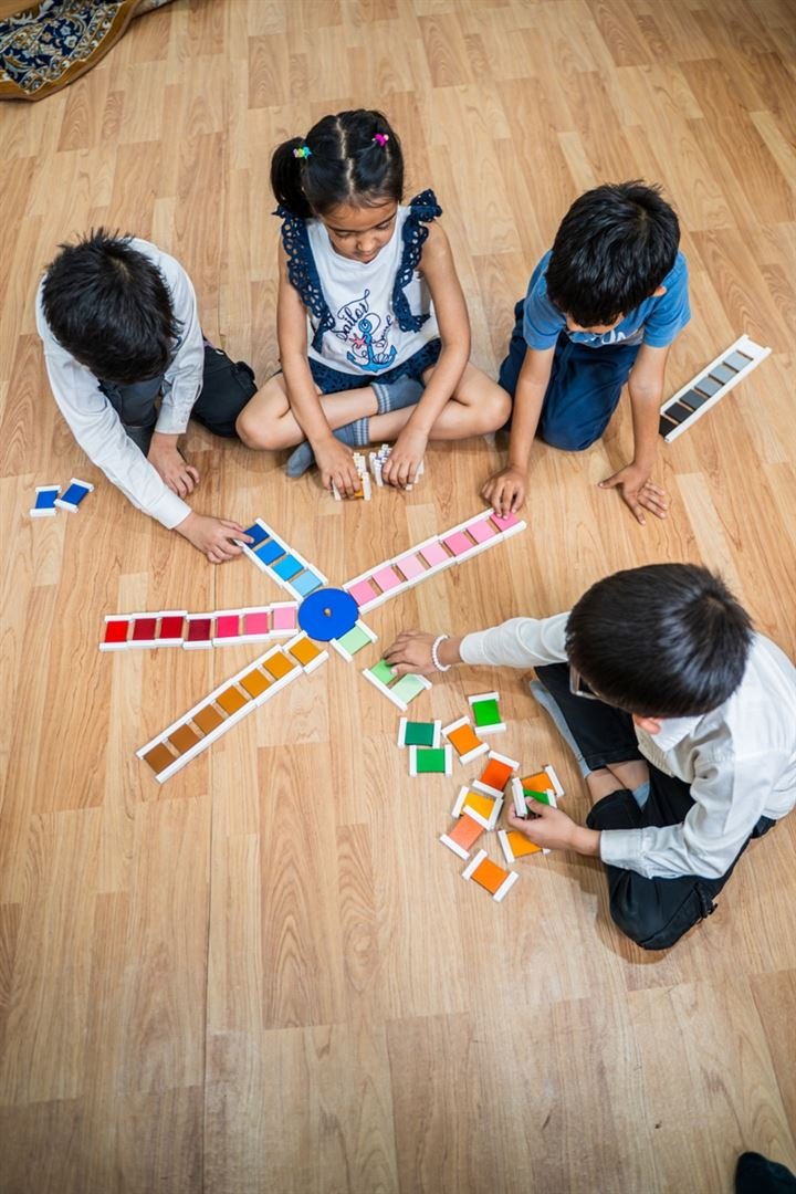 Children arranging colour tablets together on the classroom floor