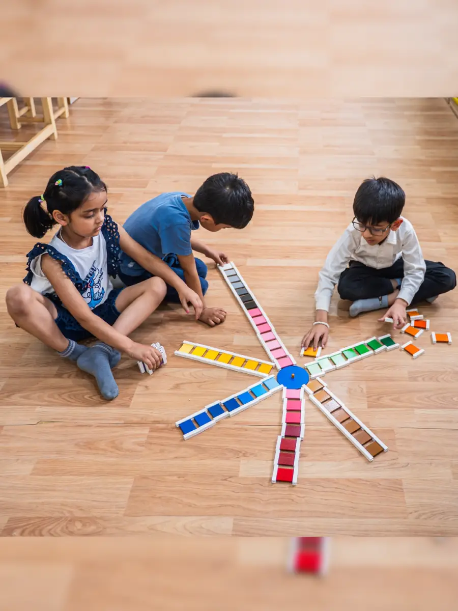 Children arranging colour tablets in a circle on the floor